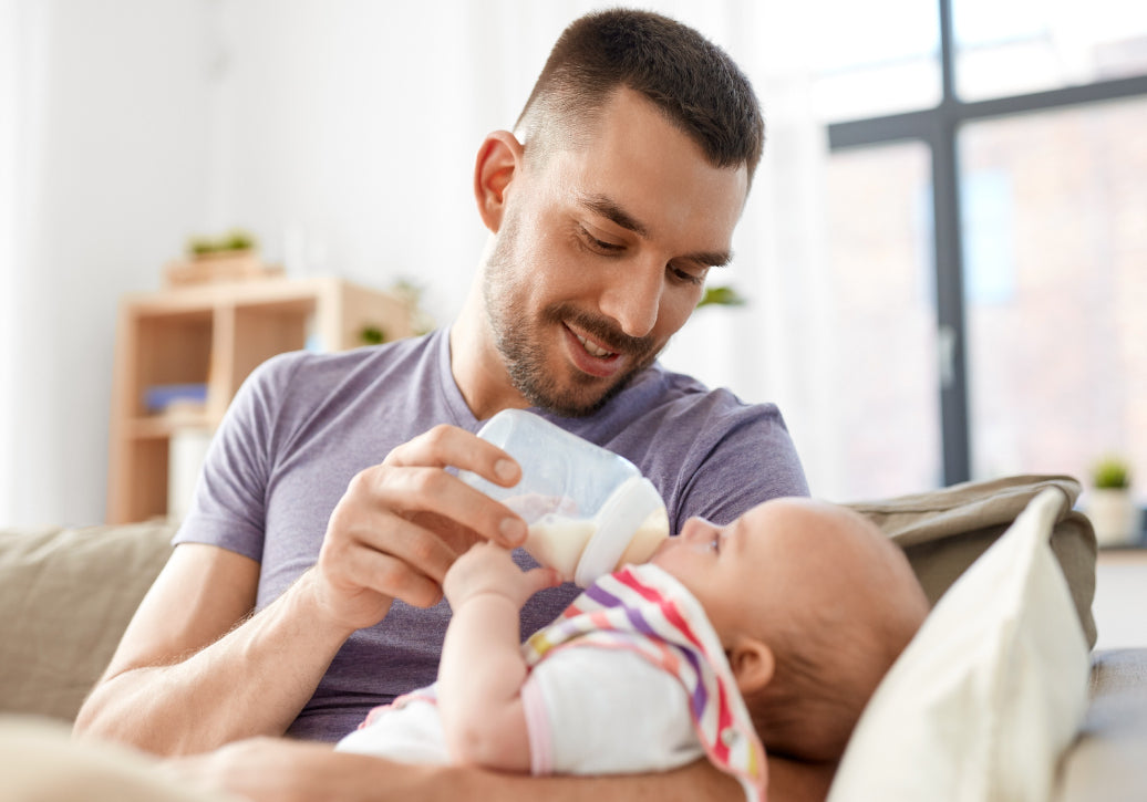 Father feeding a baby from a bottle