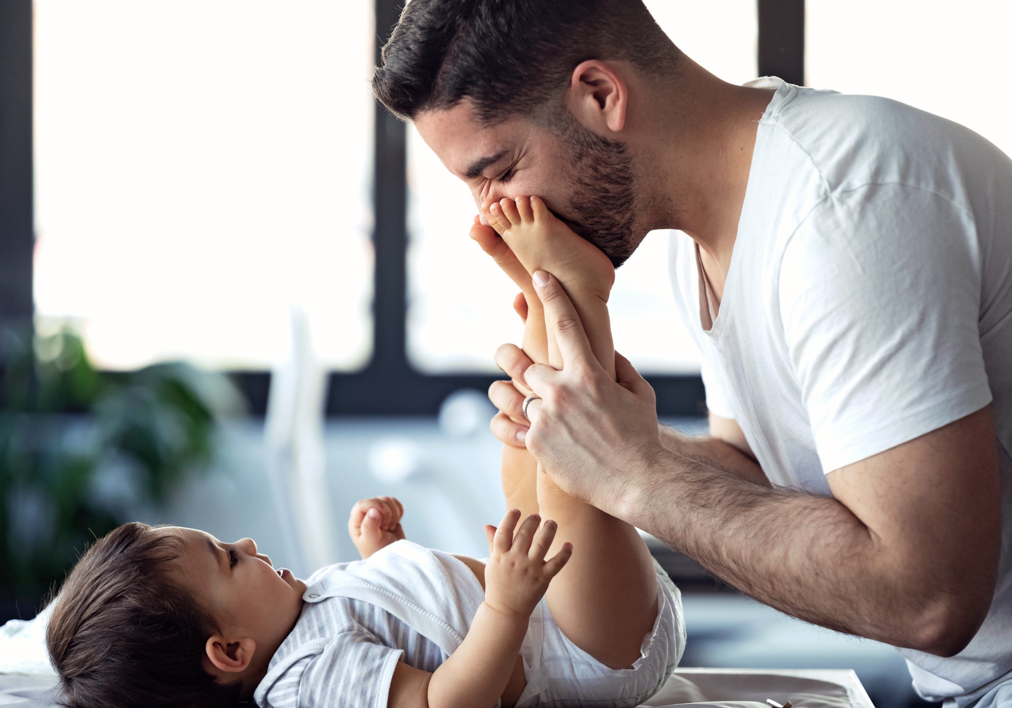 A baby in a nappy with parent