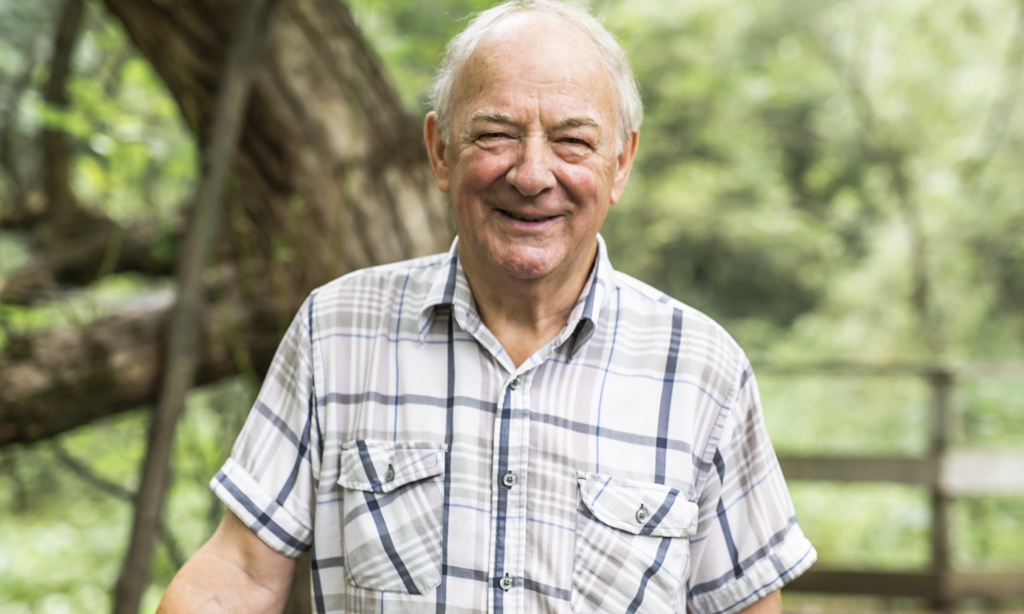 Man in checked shirt walking in countryside