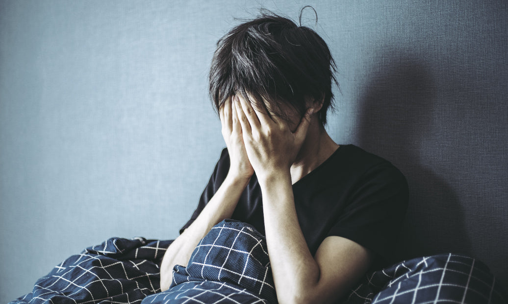 Distressed person sitting up in bed