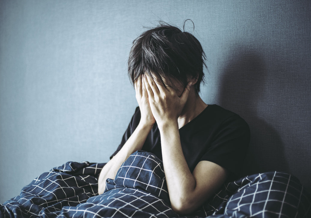 Distressed person sitting up in bed