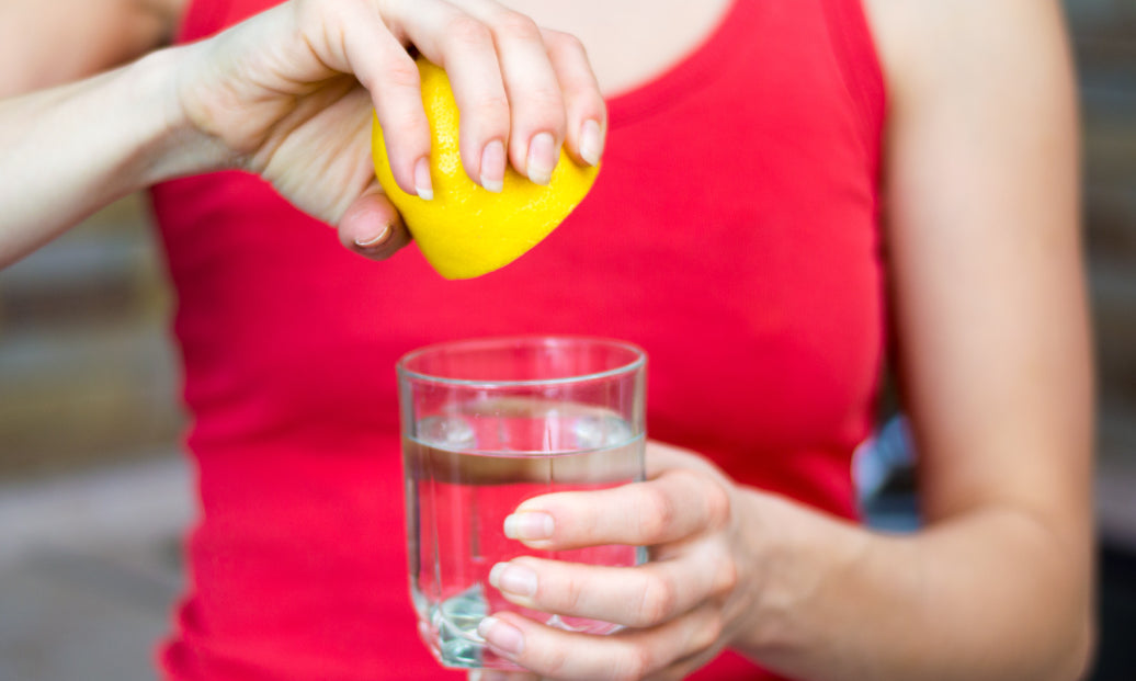 Squeezing lemon juice into some water