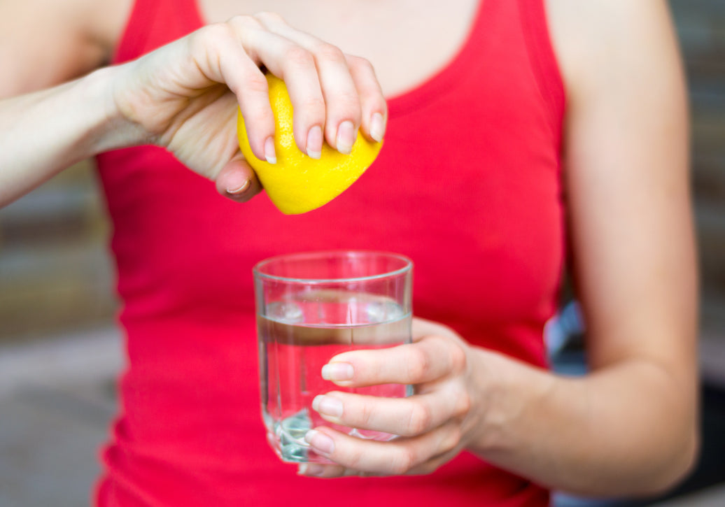 Squeezing lemon juice into some water