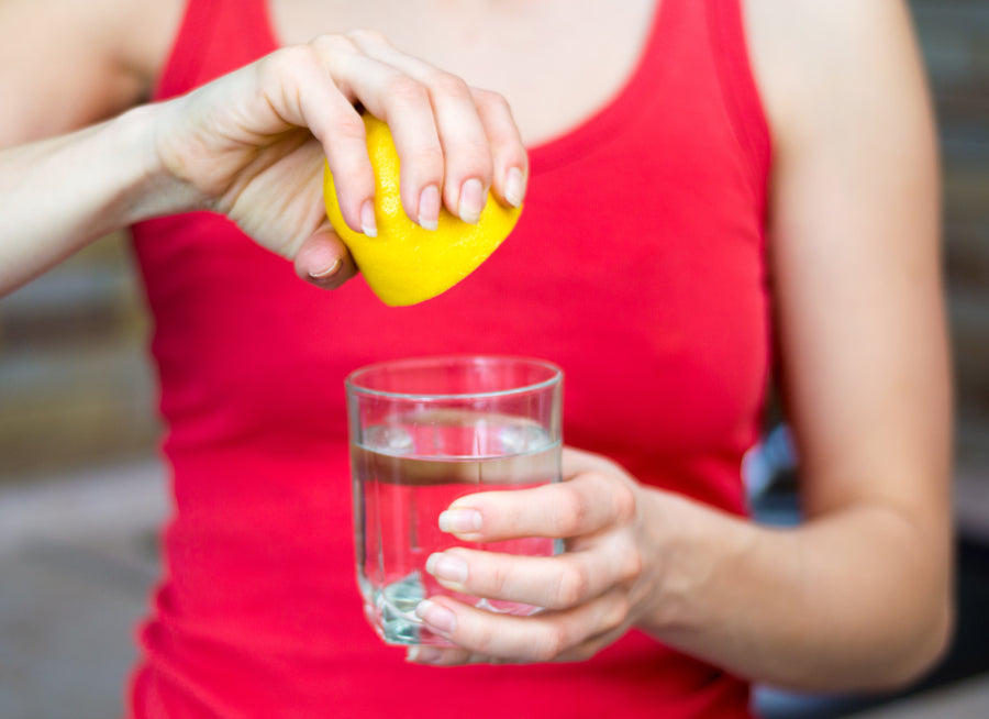 Squeezing lemon juice into some water