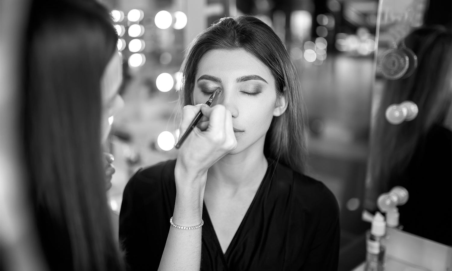 Makeup Artist applying makeup to person