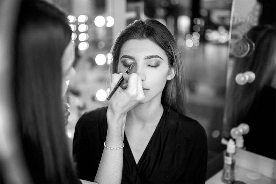 Makeup Artist applying makeup to person