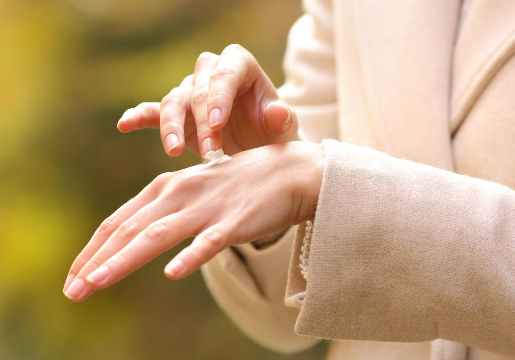 Rubbing cream into the back of a hand on a cold winter day