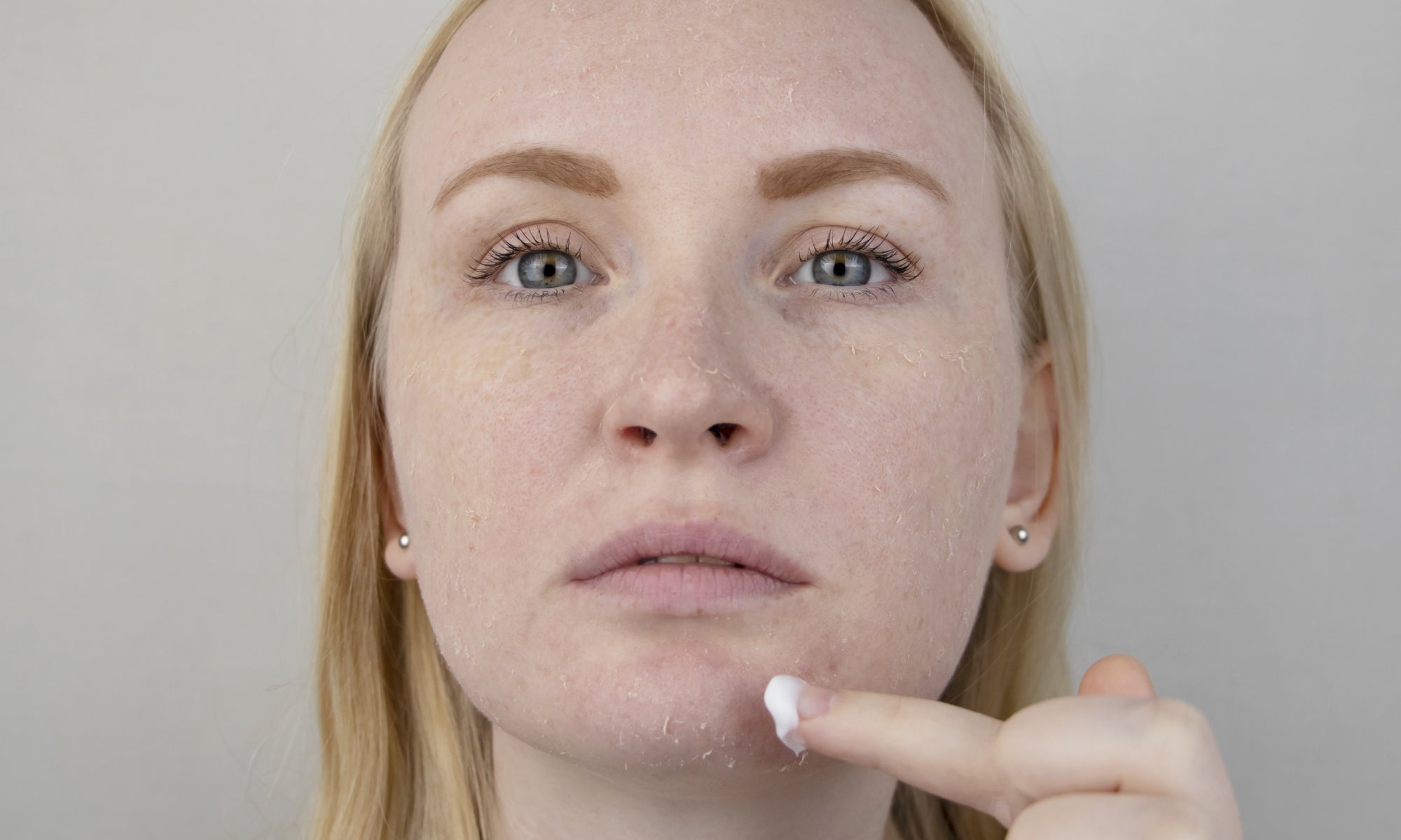 Applying cream to face