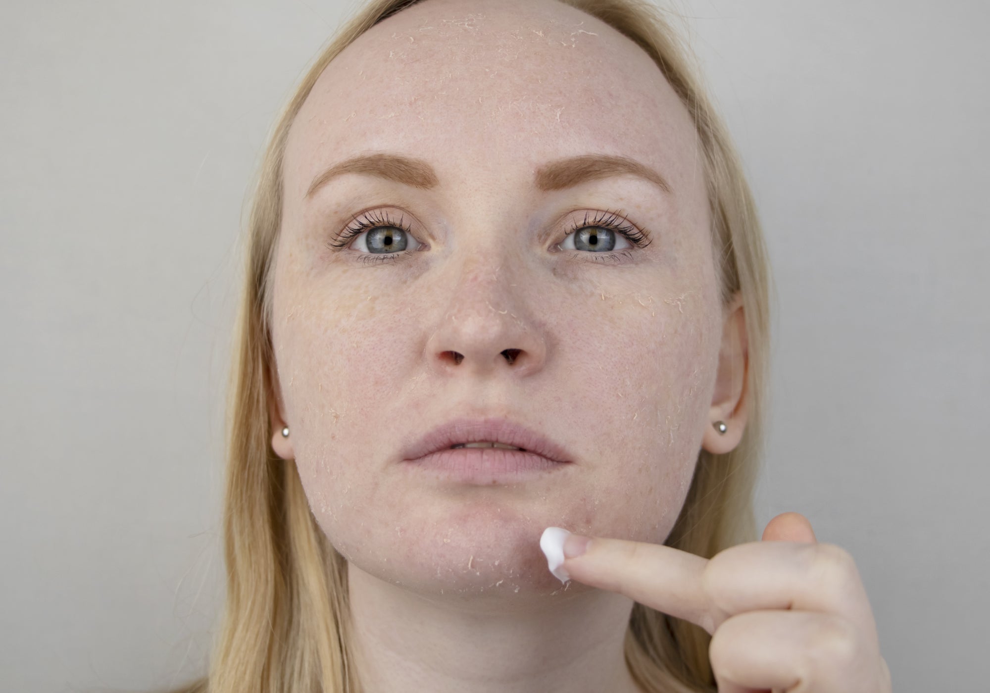 Applying cream to face